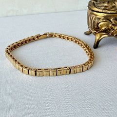Vintage Napier gold‑tone cube link bracelet with articulated square links and signed fold‑over clasp.