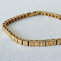 Vintage Napier gold‑tone cube link bracelet with articulated square links and signed fold‑over clasp.