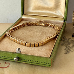 Vintage Napier gold‑tone cube link bracelet with articulated square links and signed fold‑over clasp.