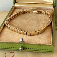 Vintage Napier gold‑tone cube link bracelet with articulated square links and signed fold‑over clasp.