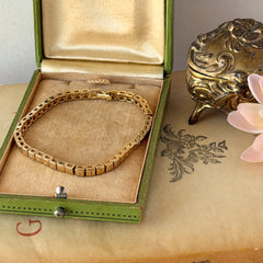 Vintage Napier gold‑tone cube link bracelet with articulated square links and signed fold‑over clasp.