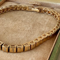 Vintage Napier gold‑tone cube link bracelet with articulated square links and signed fold‑over clasp.