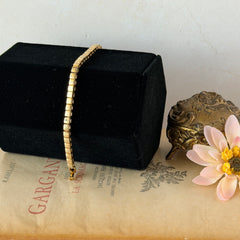 Vintage Napier gold‑tone cube link bracelet with articulated square links and signed fold‑over clasp.