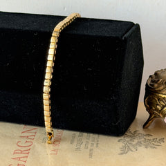 Vintage Napier gold‑tone cube link bracelet with articulated square links and signed fold‑over clasp.