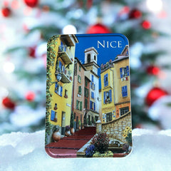 French holiday tin gift box with two mini Marseille soaps and a lavender sachet nestled in crinkle paper, available in Paris, Nice, or Côte d’Azur designs — a festive surprise gift from France.