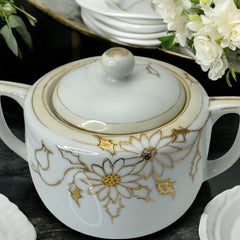 Vintage Nippon porcelain sugar bowl and creamer set with hand-painted gold floral design on white glaze; sugar bowl with dual handles and lid, creamer with spout and single handle; both marked “Hand Painted Nippon” with sun emblem on base.