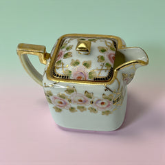 Antique Nippon Morimura Brothers square porcelain creamer with lid, hand-painted pink roses, gold moriage accents, and faded green maker’s mark on base.