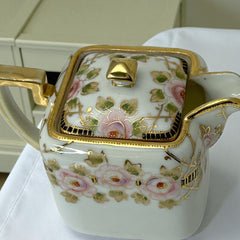 Antique Nippon Morimura Brothers square porcelain creamer with lid, hand-painted pink roses, gold moriage accents, and faded green maker’s mark on base.