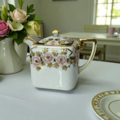 Antique Nippon Morimura Brothers square porcelain creamer with lid, hand-painted pink roses, gold moriage accents, and faded green maker’s mark on base.