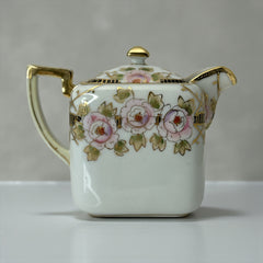 Antique Nippon Morimura Brothers square porcelain creamer with lid, hand-painted pink roses, gold moriage accents, and faded green maker’s mark on base.