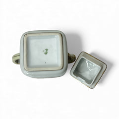 Antique Nippon Morimura Brothers square porcelain creamer with lid, hand-painted pink roses, gold moriage accents, and faded green maker’s mark on base.