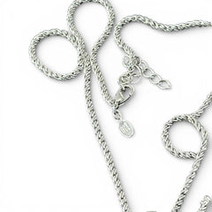 Vintage Nolan Miller silver-tone key pendant necklace with clear rhinestones in heart and infinity design, shown on twisted rope chain.