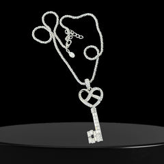 Vintage Nolan Miller silver-tone key pendant necklace with clear rhinestones in heart and infinity design, shown on twisted rope chain.