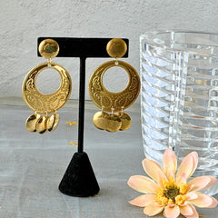 Vintage 1980s gold‑tone circle dangle post earrings with embossed paisley design and dangling discs, displayed on original Impressions card.