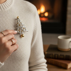 Vintage Paquette Christmas tree brooch in silver and gold-tone metal, featuring a modernist design with circular cutouts and a gold star at the top; signed on the back, circa 1990s, in very good condition