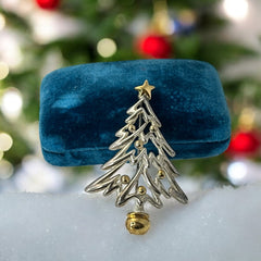 Vintage Paquette Christmas tree brooch in silver and gold-tone metal, featuring a modernist design with circular cutouts and a gold star at the top; signed on the back, circa 1990s, in very good condition.