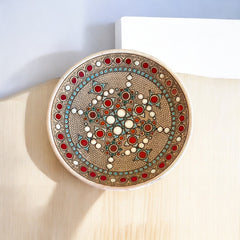 Vintage French studio pottery bowl by Paul Dordet, hand-formed in textured buff clay with red, white, and blue glazed circular motifs; signed on the underside and shown with hanging wire for optional wall display.