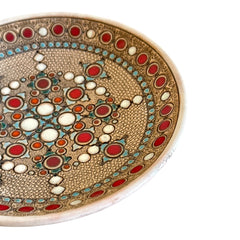 Vintage French studio pottery bowl by Paul Dordet, hand-formed in textured buff clay with red, white, and blue glazed circular motifs; signed on the underside and shown with hanging wire for optional wall display.