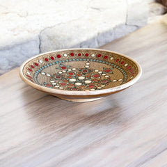 Vintage French studio pottery bowl by Paul Dordet, hand-formed in textured buff clay with red, white, and blue glazed circular motifs; signed on the underside and shown with hanging wire for optional wall display.