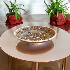 Vintage French studio pottery bowl by Paul Dordet, hand-formed in textured buff clay with red, white, and blue glazed circular motifs; signed on the underside and shown with hanging wire for optional wall display.