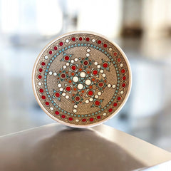 Vintage French studio pottery bowl by Paul Dordet, hand-formed in textured buff clay with red, white, and blue glazed circular motifs; signed on the underside and shown with hanging wire for optional wall display.