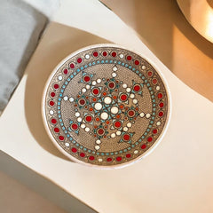 Vintage French studio pottery bowl by Paul Dordet, hand-formed in textured buff clay with red, white, and blue glazed circular motifs; signed on the underside and shown with hanging wire for optional wall display.