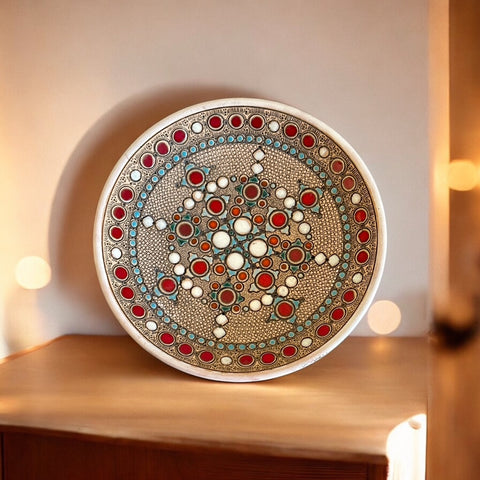 Vintage French studio pottery bowl by Paul Dordet, hand-formed in textured buff clay with red, white, and blue glazed circular motifs; signed on the underside and shown with hanging wire for optional wall display.