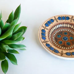 Rare vintage French studio pottery bowl by Paul Dordet, featuring textured buff and terracotta clay with blue and white glazed circles in an orientalist pattern; signed on the underside and suitable for display flat or wall-hung.