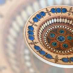 Rare vintage French studio pottery bowl by Paul Dordet, featuring textured buff and terracotta clay with blue and white glazed circles in an orientalist pattern; signed on the underside and suitable for display flat or wall-hung.