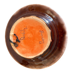 Rare vintage French studio pottery bowl by Paul Dordet, featuring textured buff and terracotta clay with blue and white glazed circles in an orientalist pattern; signed on the underside and suitable for display flat or wall-hung.
