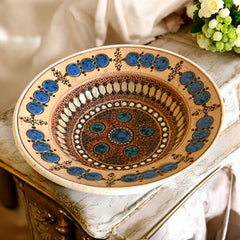 Rare vintage French studio pottery bowl by Paul Dordet, featuring textured buff and terracotta clay with blue and white glazed circles in an orientalist pattern; signed on the underside and suitable for display flat or wall-hung.