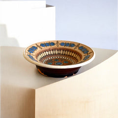Rare vintage French studio pottery bowl by Paul Dordet, featuring textured buff and terracotta clay with blue and white glazed circles in an orientalist pattern; signed on the underside and suitable for display flat or wall-hung.