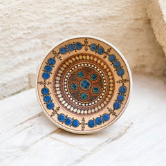 Rare vintage French studio pottery bowl by Paul Dordet, featuring textured buff and terracotta clay with blue and white glazed circles in an orientalist pattern; signed on the underside and suitable for display flat or wall-hung.