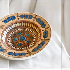 Rare vintage French studio pottery bowl by Paul Dordet, featuring textured buff and terracotta clay with blue and white glazed circles in an orientalist pattern; signed on the underside and suitable for display flat or wall-hung.