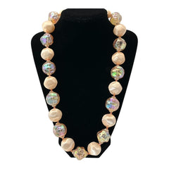 Vintage 1950s/1960s single-strand necklace featuring light peach hollow plastic beads alternating between opaque satin and iridescent transparent beads, finished with a snap clasp adorned with a light peach satin cabochon, signed Japan, in very good vintage condition.