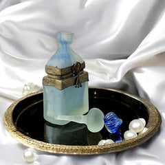 Vintage Romanian art glass perfume bottle from the 1990s, featuring frosted blue and green glass with a sculptural swirled stopper and bronze wire bow detail around the neck. Square base with a tapered neck; dauber slightly shortened due to breakage.
