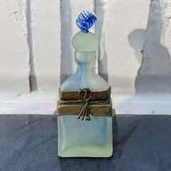 Vintage Romanian art glass perfume bottle from the 1990s, featuring frosted blue and green glass with a sculptural swirled stopper and bronze wire bow detail around the neck. Square base with a tapered neck; dauber slightly shortened due to breakage.
