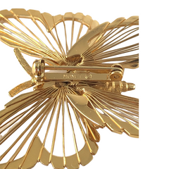 Vintage Monet gold‑tone butterfly brooch with openwork wire wings