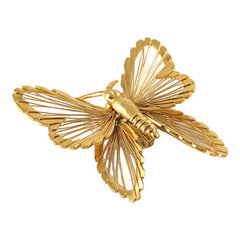 Vintage Monet gold‑tone butterfly brooch with openwork wire wings