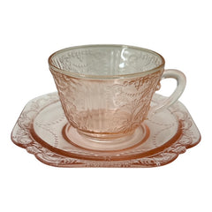 Vintage pink depression glass set featuring 2 delicate cups from the American Sweetheart collection and 2 square saucers from the Madrid collection, both adorned with intricate floral and geometric etched patterns. A timeless and sustainable addition to any table or décor.