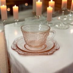 Vintage pink depression glass set featuring 2 delicate cups from the American Sweetheart collection and 2 square saucers from the Madrid collection, both adorned with intricate floral and geometric etched patterns. A timeless and sustainable addition to any table or décor.