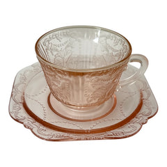 Vintage pink depression glass set featuring 2 delicate cups from the American Sweetheart collection and 2 square saucers from the Madrid collection, both adorned with intricate floral and geometric etched patterns. A timeless and sustainable addition to any table or décor.