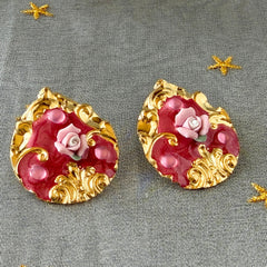 Vintage 1980s teardrop post earrings with 3D pink polymer clay rose, pink enamel base, and gold tone pressed metal scrollwork on original card.