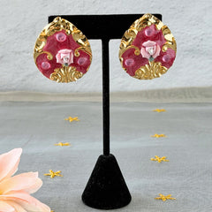 Vintage 1980s teardrop post earrings with 3D pink polymer clay rose, pink enamel base, and gold tone pressed metal scrollwork on original card.