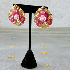 Vintage 1980s teardrop post earrings with 3D pink polymer clay rose, pink enamel base, and gold tone pressed metal scrollwork on original card.