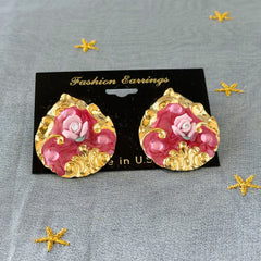 Vintage 1980s teardrop post earrings with 3D pink polymer clay rose, pink enamel base, and gold tone pressed metal scrollwork on original card.