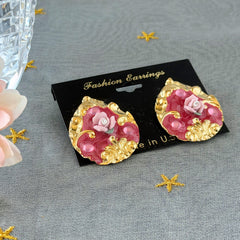 Vintage 1980s teardrop post earrings with 3D pink polymer clay rose, pink enamel base, and gold tone pressed metal scrollwork on original card.