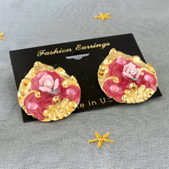 Vintage 1980s teardrop post earrings with 3D pink polymer clay rose, pink enamel base, and gold tone pressed metal scrollwork on original card.