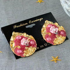 Vintage 1980s teardrop post earrings with 3D pink polymer clay rose, pink enamel base, and gold tone pressed metal scrollwork on original card.