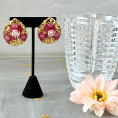 Vintage 1980s teardrop post earrings with 3D pink polymer clay rose, pink enamel base, and gold tone pressed metal scrollwork on original card.